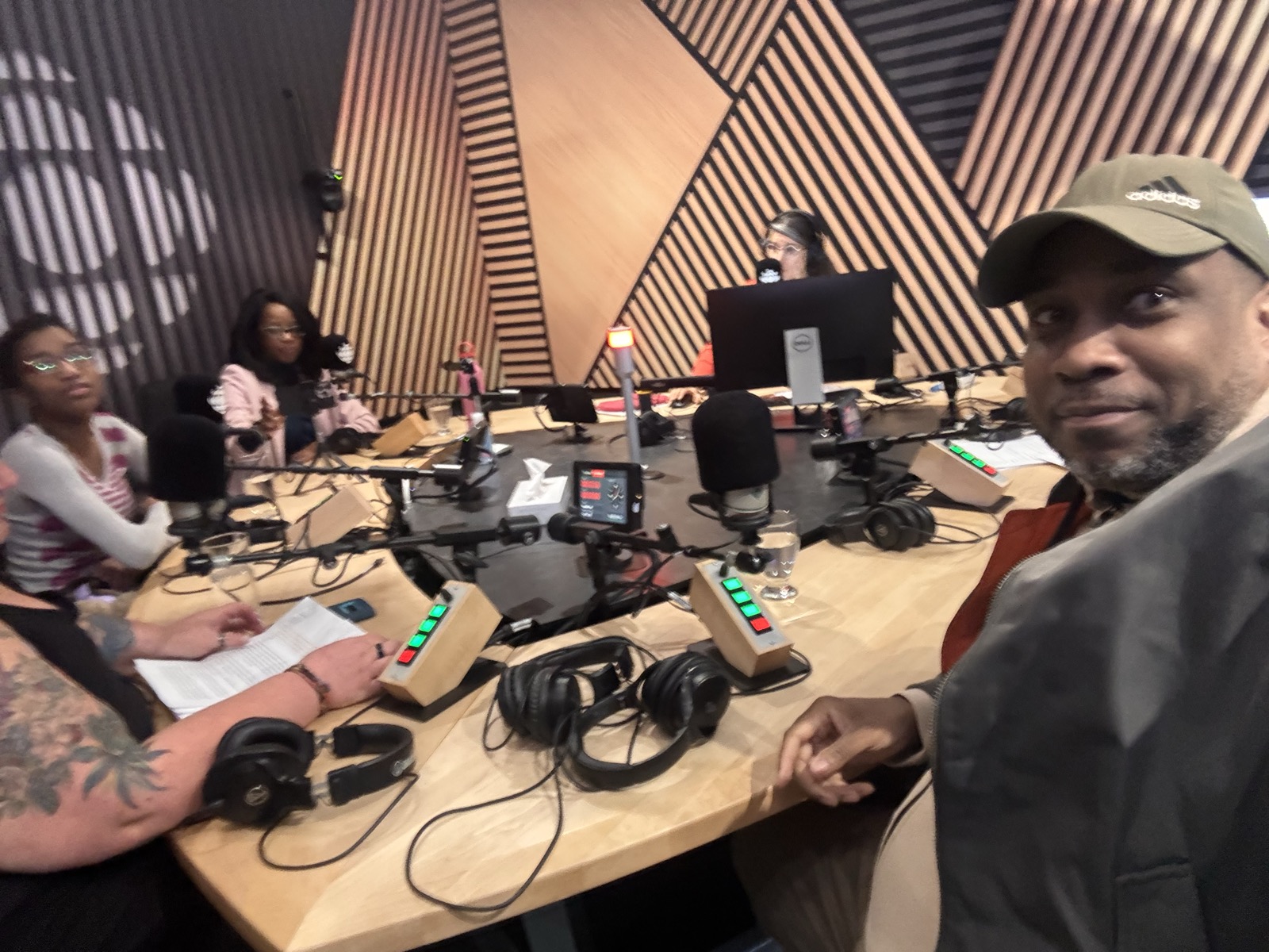 David Elisma in a Radio-Canada studio, at the recording table with the show's team